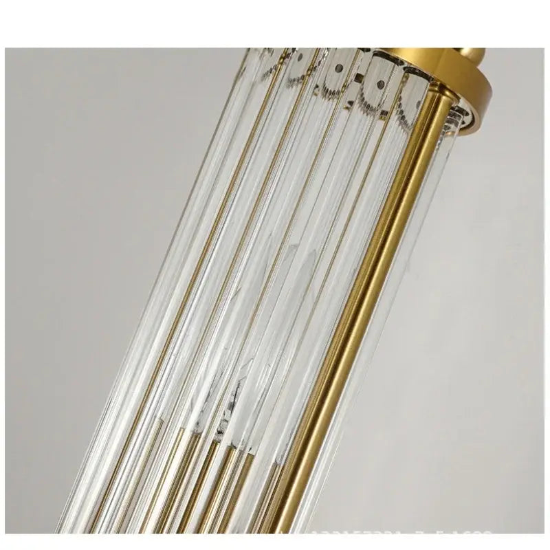 A modern gold decorbites crystal led wall light with slender transparent glass rods and a polished brass frame
