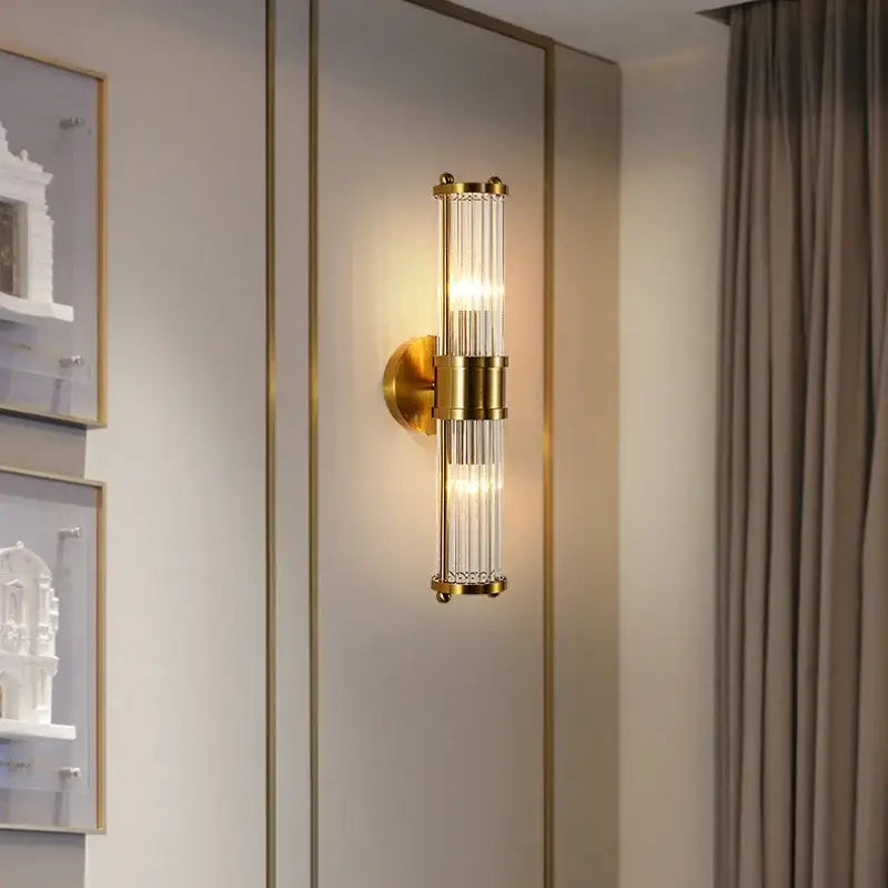 Modern gold decorbites crystal led wall lights featuring a gold-toned vertical crystal rod design for bedroom sconce use