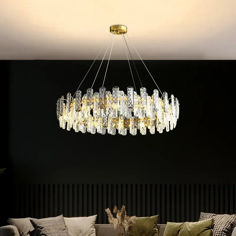 A modern gold decorbites crystal round chandelier with clear crystal prisms for elegant dining room lighting