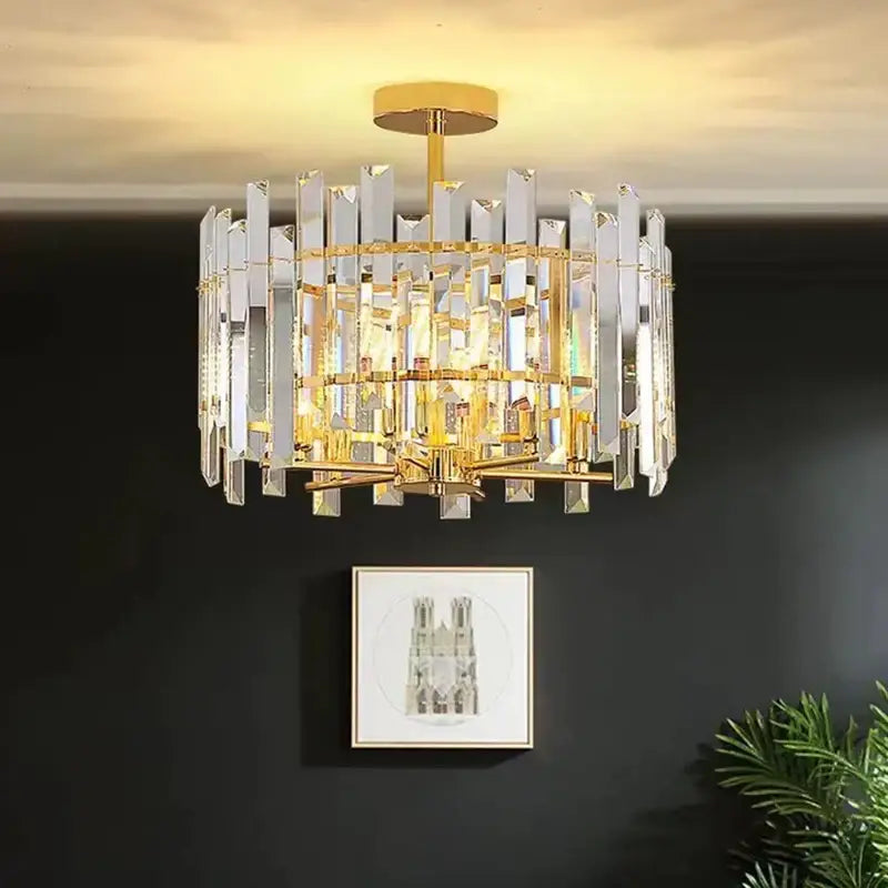 Modern gold decorbites crystal round chandelier with a gold metal frame and cascading clear crystal prisms for living room light