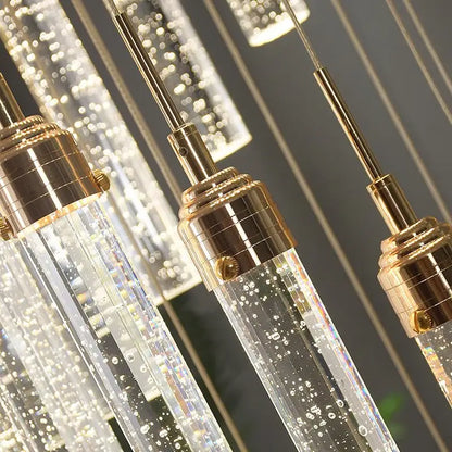 Modern gold decorbites crystal staircase chandelier with clear glass and gold-toned metal fixtures with internal led lights