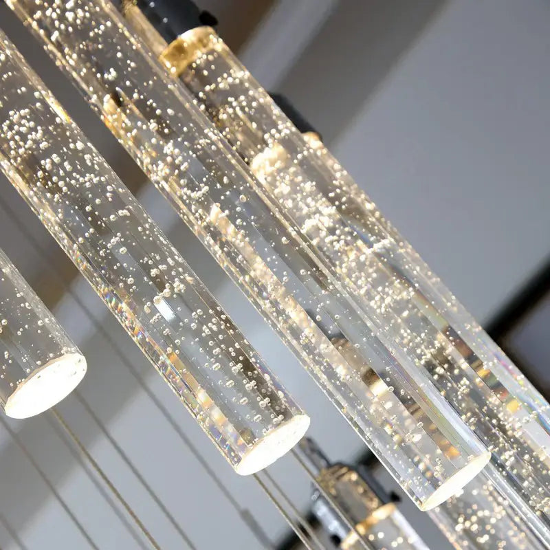Modern gold decorbites deluxe crystal chandelier features clear glass cylindrical pendant lights with golden bubbles and warm led illumination