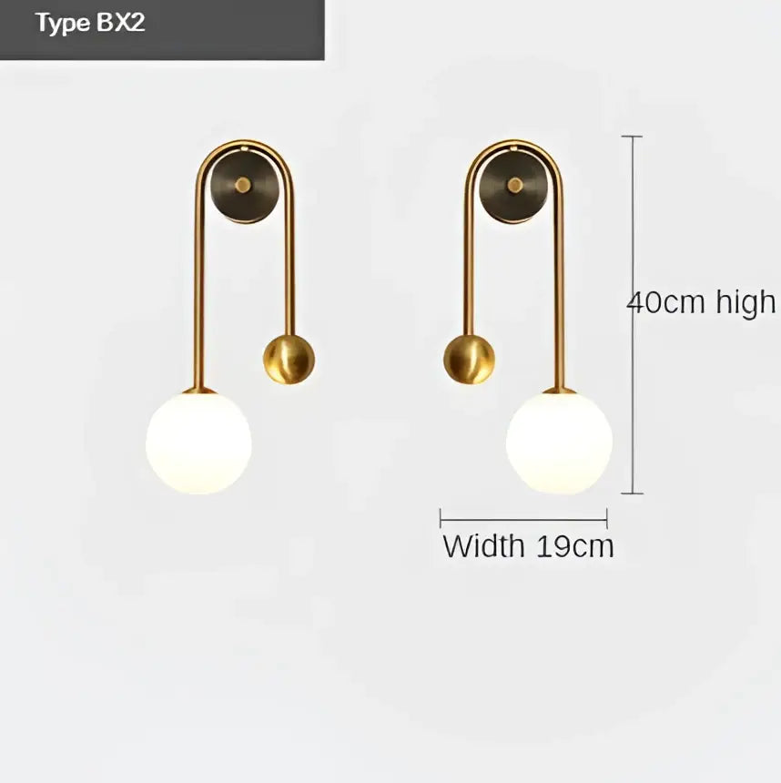 Brass-finished wall lamp with decorbites glass ball led spherical glass globe and curved arm for modern bedroom decor