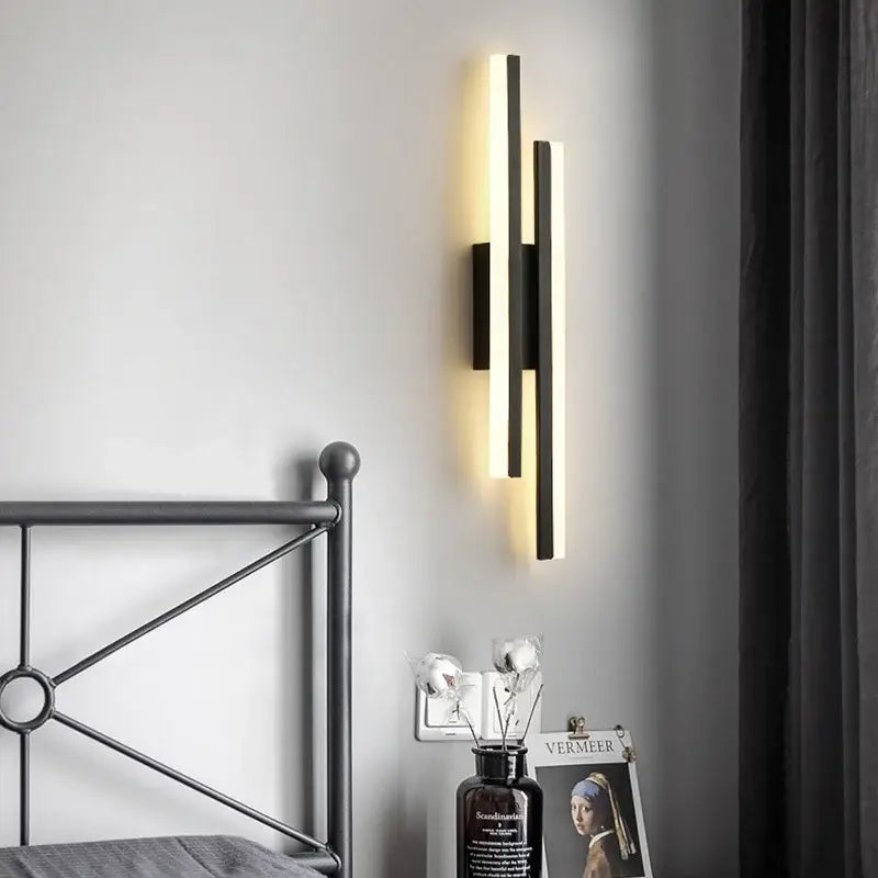 Modern black wall lamp decorbites led strip with two vertical bars emitting warm glow for bedroom sconce lighting