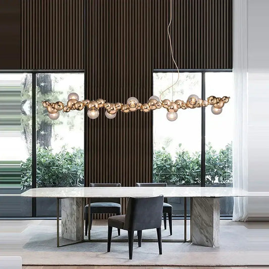 Modern gold-toned spherical pendant light fixture with a clustered design from decorbites designer molecule chandelier collection