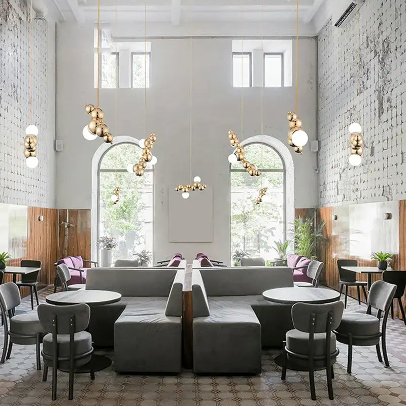 Modern gold decorbites designer molecule chandelier featuring spherical pendant lights for dining room and cafe decor