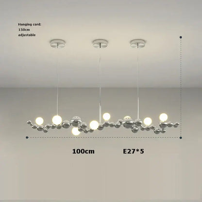 Modern chrome finished pendant chandelier with five spherical bulbs in a decorbites designer molecule dining room light
