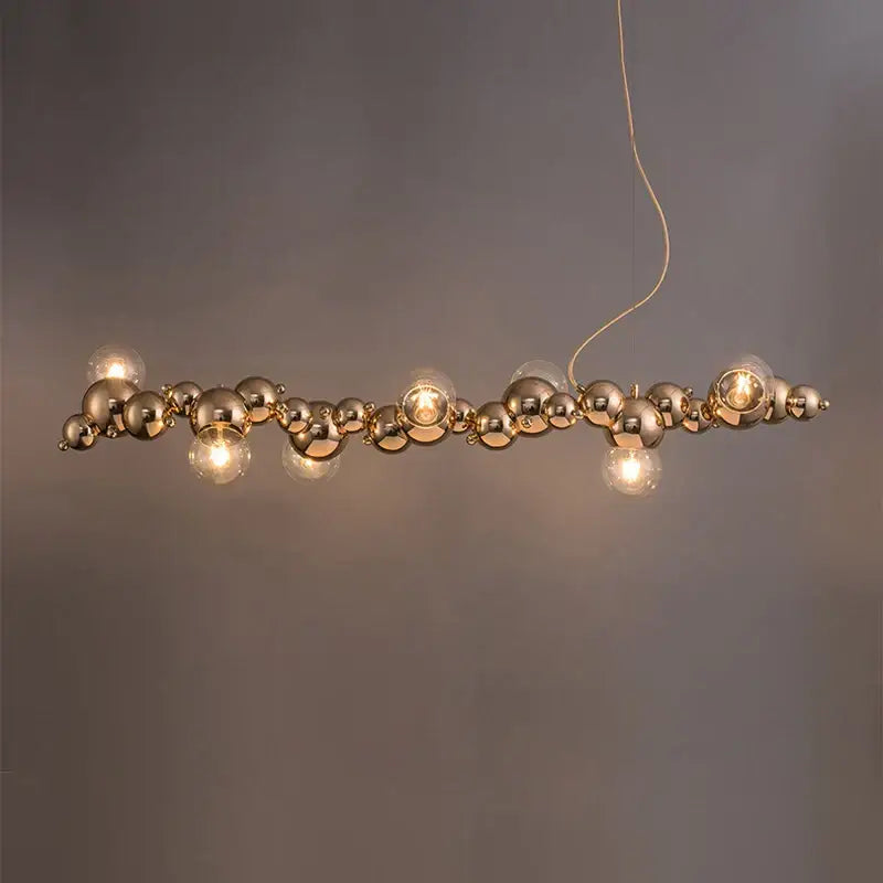 Modern gold designer molecule chandelier pendant light with interconnected spherical bulbs and exposed filament lamps by decorbites