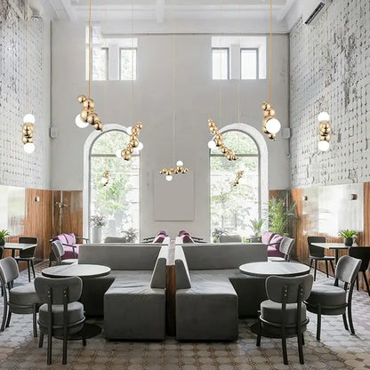Modern gold designer molecule chandelier features gold-toned spherical pendant lights for stylish café decorbites designer lighting
