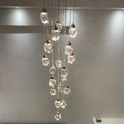 A modern gold diamond crystal ball chandelier with faceted clear glass pendants and metal fixtures for living rooms