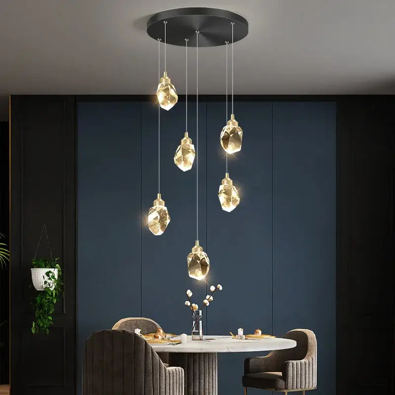 Modern gold diamond crystal ball chandelier with faceted glass shades hanging from a sleek black ceiling fixture