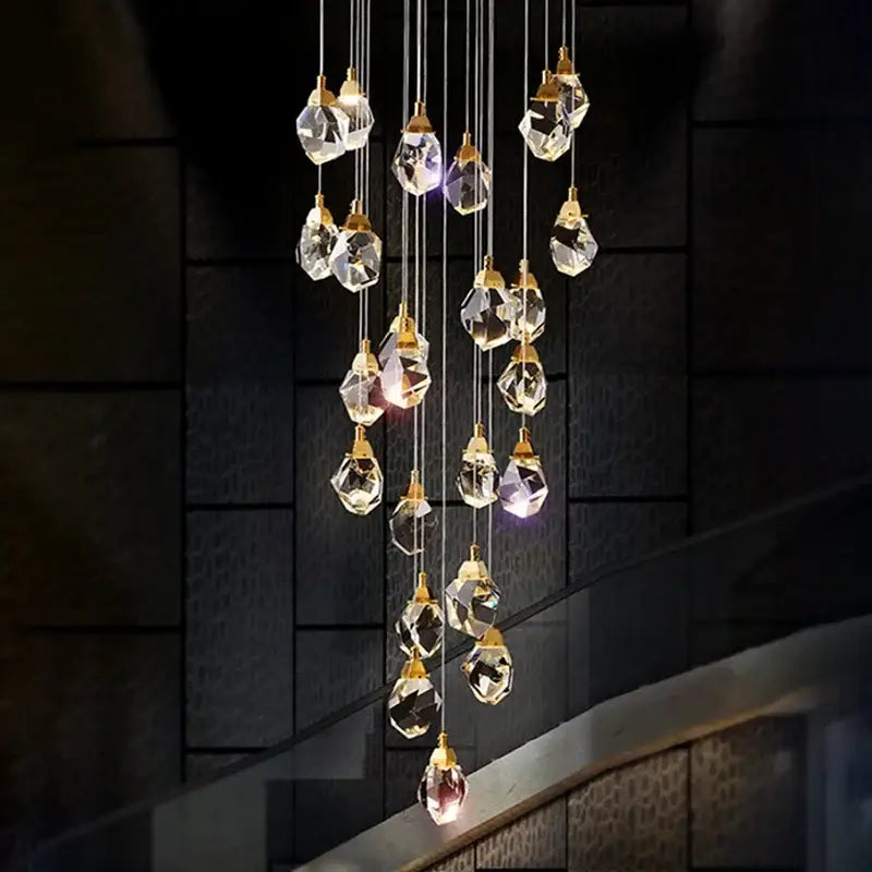 A modern gold diamond crystal chandelier with faceted clear glass droplets for living room staircase lighting