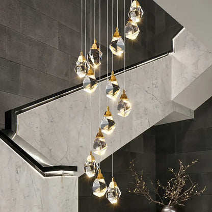 A modern gold diamond crystal led ceiling chandelier with faceted clear glass pendants for dining room use