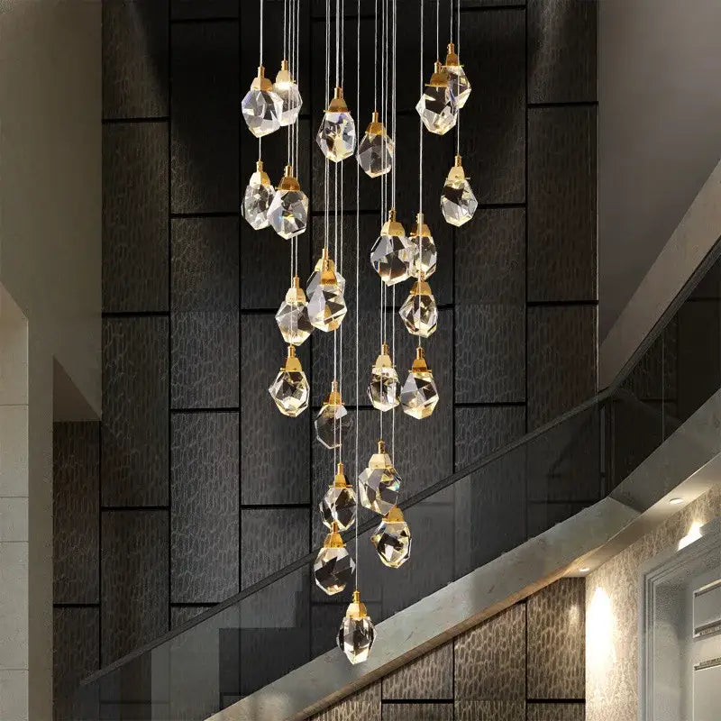 A modern gold diamond crystal led ceiling chandelier with faceted clear glass pendants for dining room use