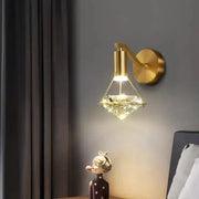 Modern gold diamond crystal wall lamp featuring a gold-finished wall sconce with a diamond-shaped crystal pendant