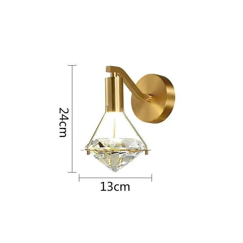 Modern gold diamond crystal wall lamp with clear crystal centerpiece designed as a diamond-shaped wall sconce