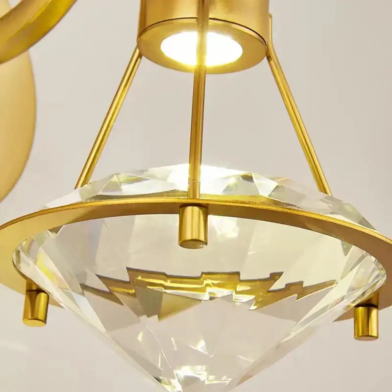 Modern gold diamond crystal wall lamp with faceted crystal shade and lightning bolt accents for bedroom use