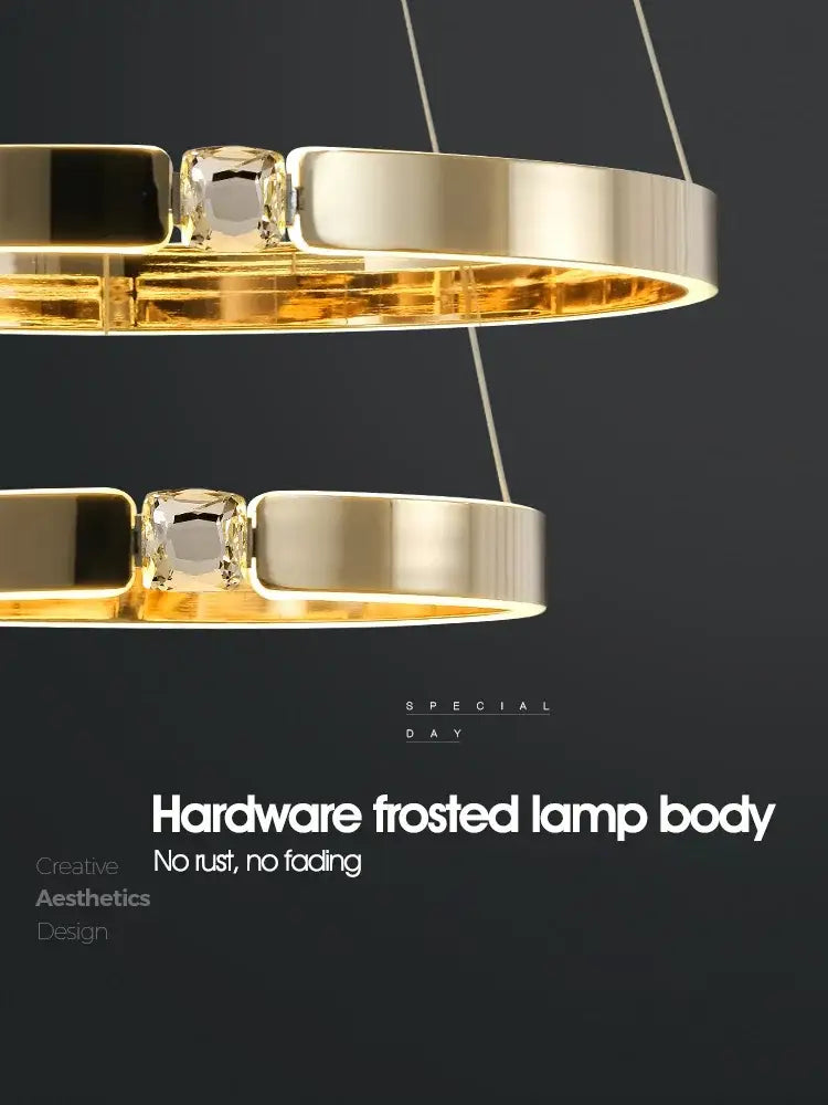 Modern gold diamond ring chandelier featuring gold-toned circular pendant lamps with frosted glass and crystal accents