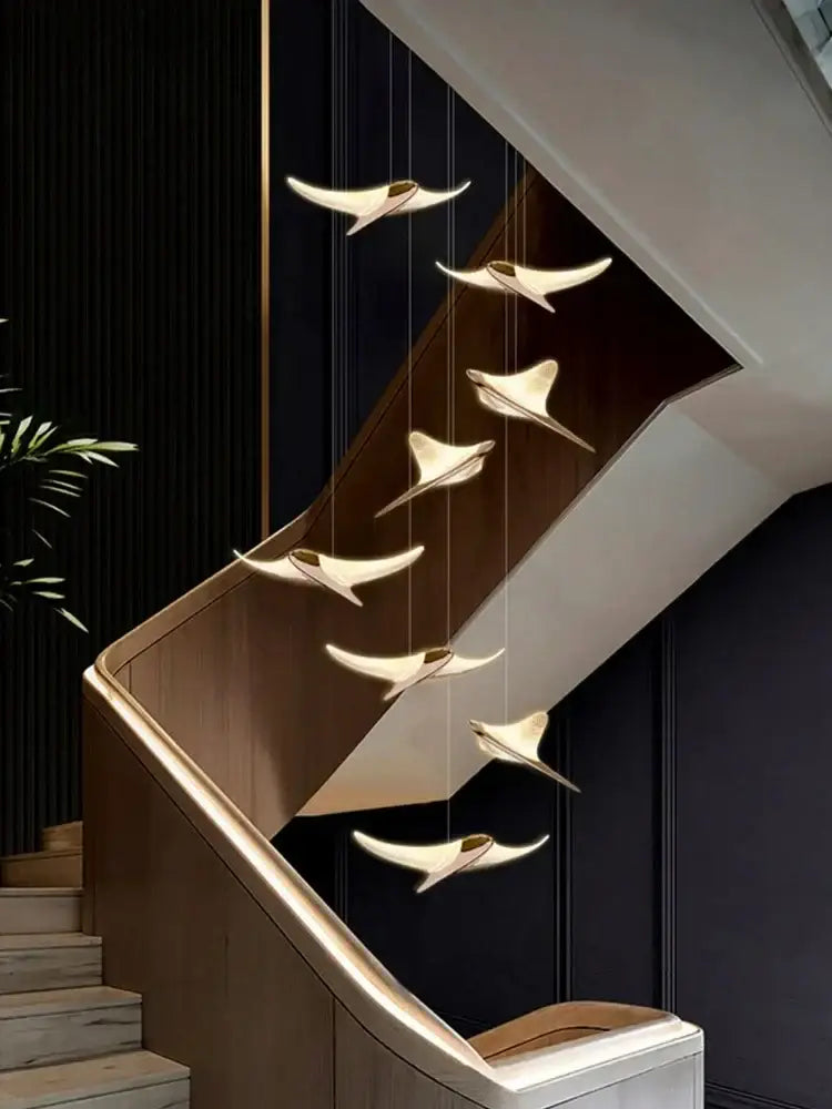 Modern gold dolphin pendant chandelier with seven sleek bird-shaped lights for hotel lobby staircase decorbites dolphin pendant