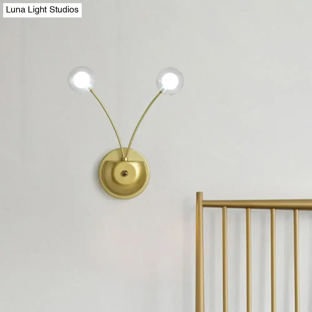 Modern gold double arm wall lamp with curved arms and clear glass globe bulbs inch fixture for bedroom use