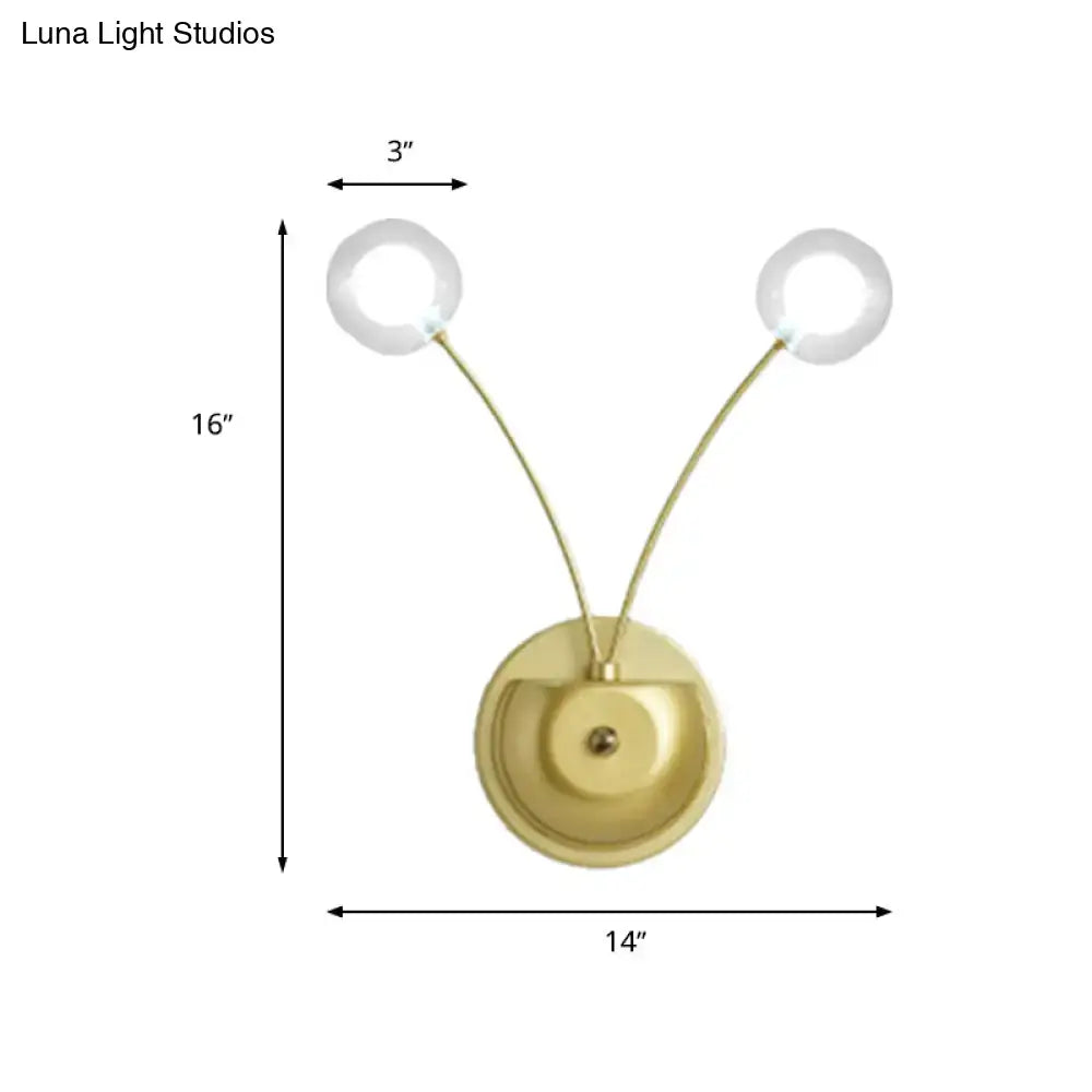 Modern gold wall lamp with two curved arms and clear globe glass shades inch fixture for bedroom lighting
