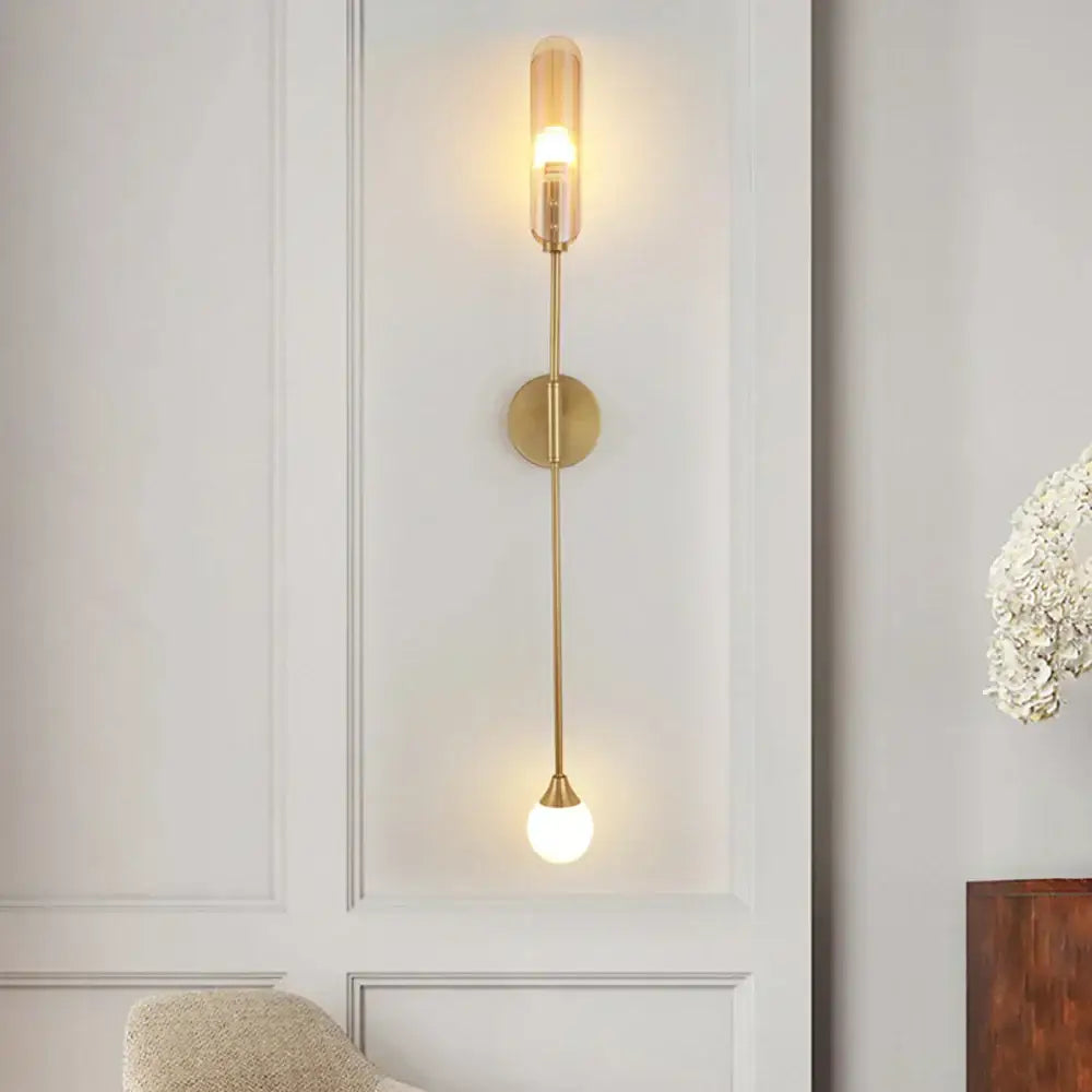 Modern gold-toned decorbites double-head wall lights with clear glass cylinder and frosted globe shade for living room decor