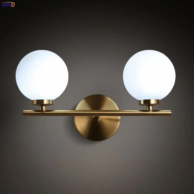 Brass-finished modern gold dual glass ball led wall lights with two frosted glass globe shades for bedroom