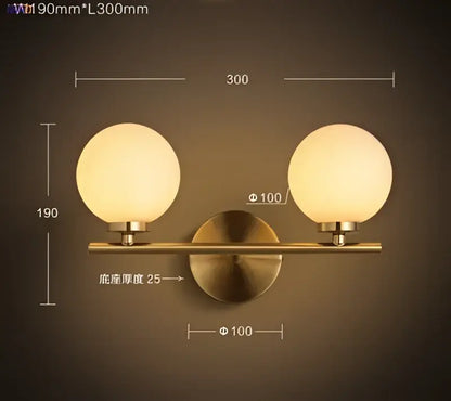 Modern gold brass-finished led wall lights with two frosted glass ball globes for bedroom lighting