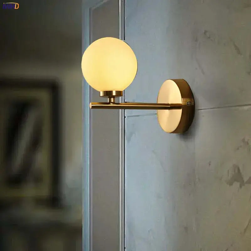 Modern gold led wall light featuring dual frosted glass ball shades ideal for stylish bedroom wall lights