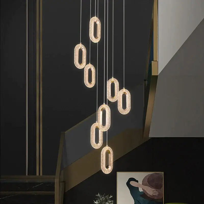 Modern gold duplex crystal chandelier featuring oval-shaped pendant lights with sparkling crystal finish for villa living room