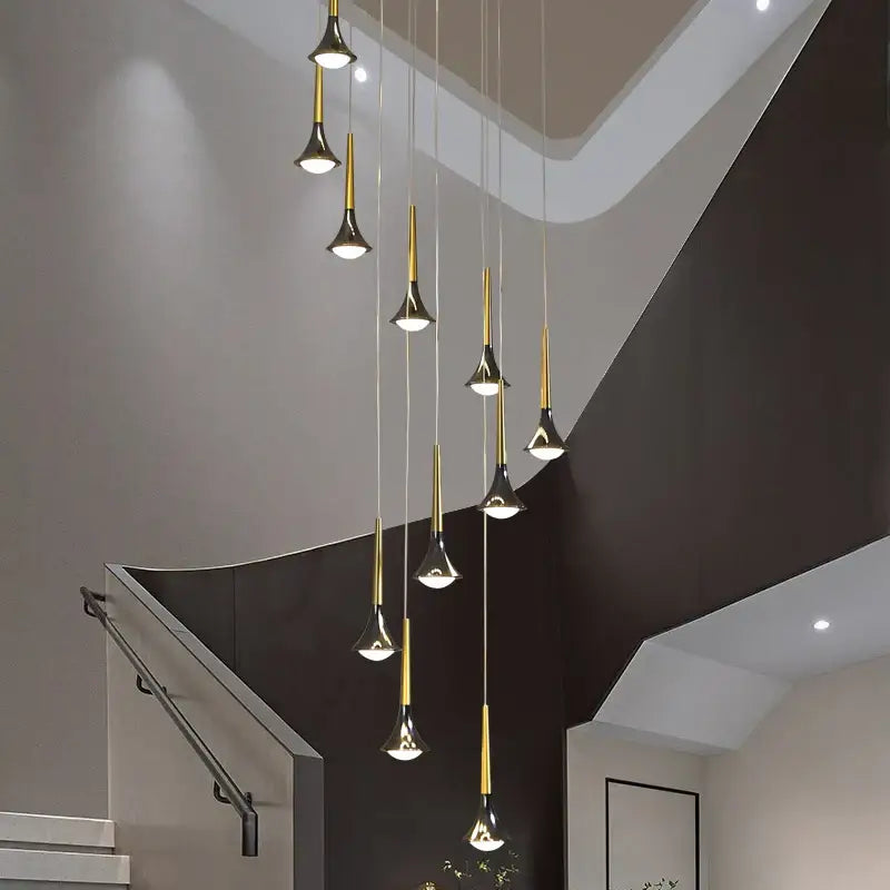 Modern gold elegant horn-shaped chandelier with black trumpet fixtures hanging staggered for staircase decorbites elegant