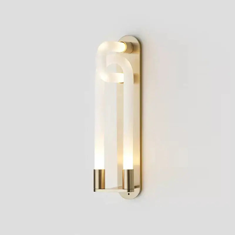 Modern gold elegant wall mounted light featuring a brass sconce with curved translucent acrylic diffuser and two vertical tubes