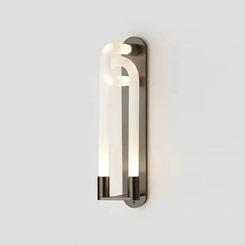 Modern gold elegant wall mounted light with a sleek curved translucent glass tube and brushed metal frame decorbites elegant wall