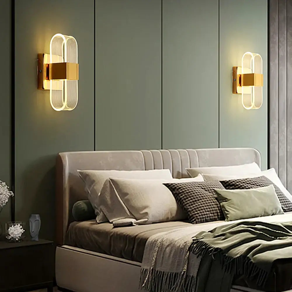 Modern gold elliptical led wall lamp featuring gold-accented oval glass panels for bedroom decorbites elliptical led wall use