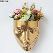 Modern gold decorbites ceramic wall-mounted vase shaped like a face with artificial pink white and green flowers for decorbites ceramic wall-mounted use