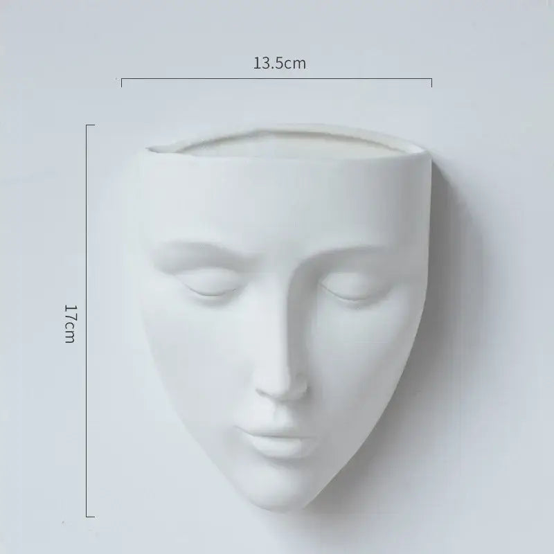Modern gold face decorbites ceramic wall-mounted vase featuring a white ceramic planter shaped like a serene face