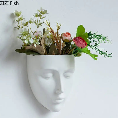 Modern gold face decorbites ceramic wall-mounted vase in white holding soft pink white artificial flowers with green foliage