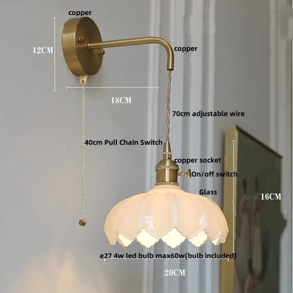 Antique brass-finished wall lamp with clear frosted glass petal shade and adjustable copper wire wall light for bedroom