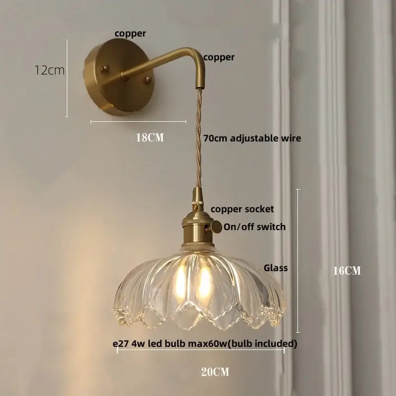 Vintage-style copper wall light with clear petal-shaped glass shade and modern gold faceted wall lamp design for bedroom