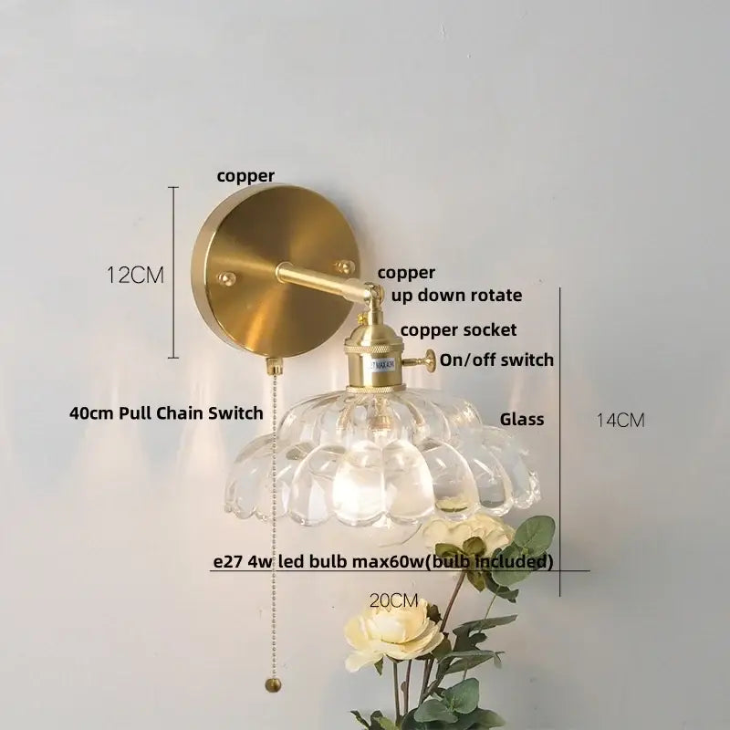 A vintage-style wall lamp with a brass copper finish and clear glass shade designed as a modern gold faceted wall light