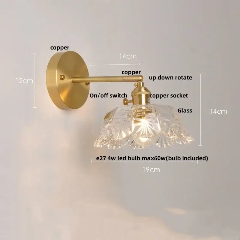 Modern gold wall light featuring a brass copper finish and a clear faceted glass wall lamp for bedroom use