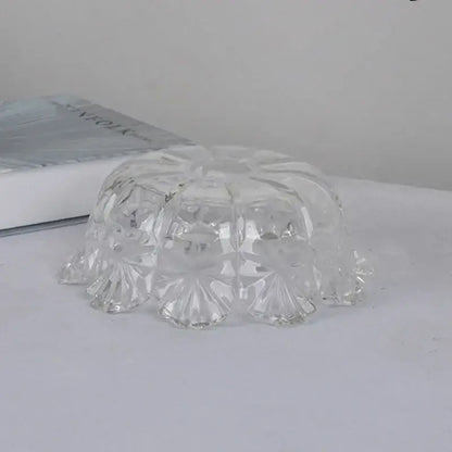 Modern gold faceted clear glass wall light with a clear glass bowl featuring intricate floral patterns for bedroom use