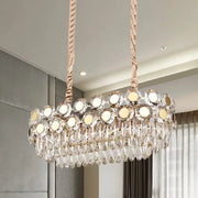 Decorbites 12-head gold suspension light fixture with oval faceted crystal droplets and mirrored discs reflecting warm light