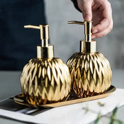 Modern gold faceted glass liquid soap dispenser set with matching pump tops for bathroom decor and liquid soap use