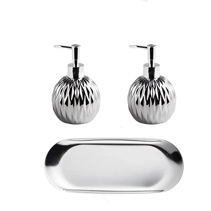 Pair of silver textured liquid soap dispenser pump bottles on a sleek oval tray for modern bathroom decor