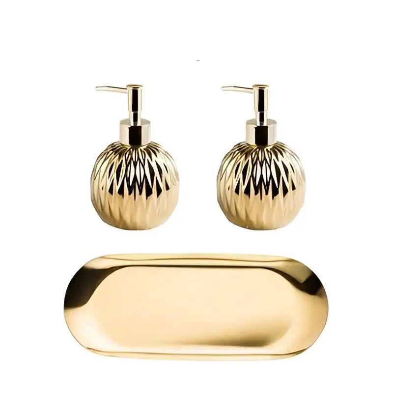 Modern gold faceted glass liquid soap dispenser set with ribbed gold finish and matching oval tray for bathroom decor