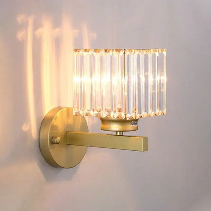 Modern gold wall lamp with a rectangular faceted glass shade composed of vertical glass rods for living room use