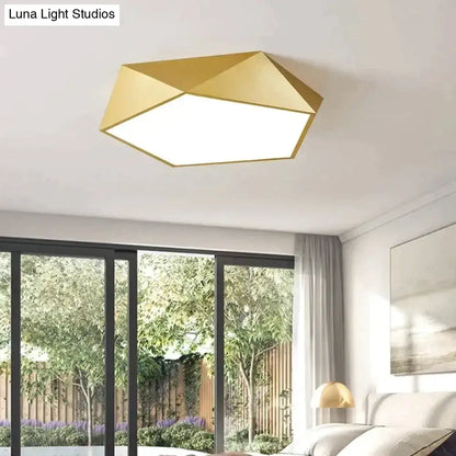 Gold geometric ceiling light with a modern faceted design and illuminated white panel for indoor living spaces