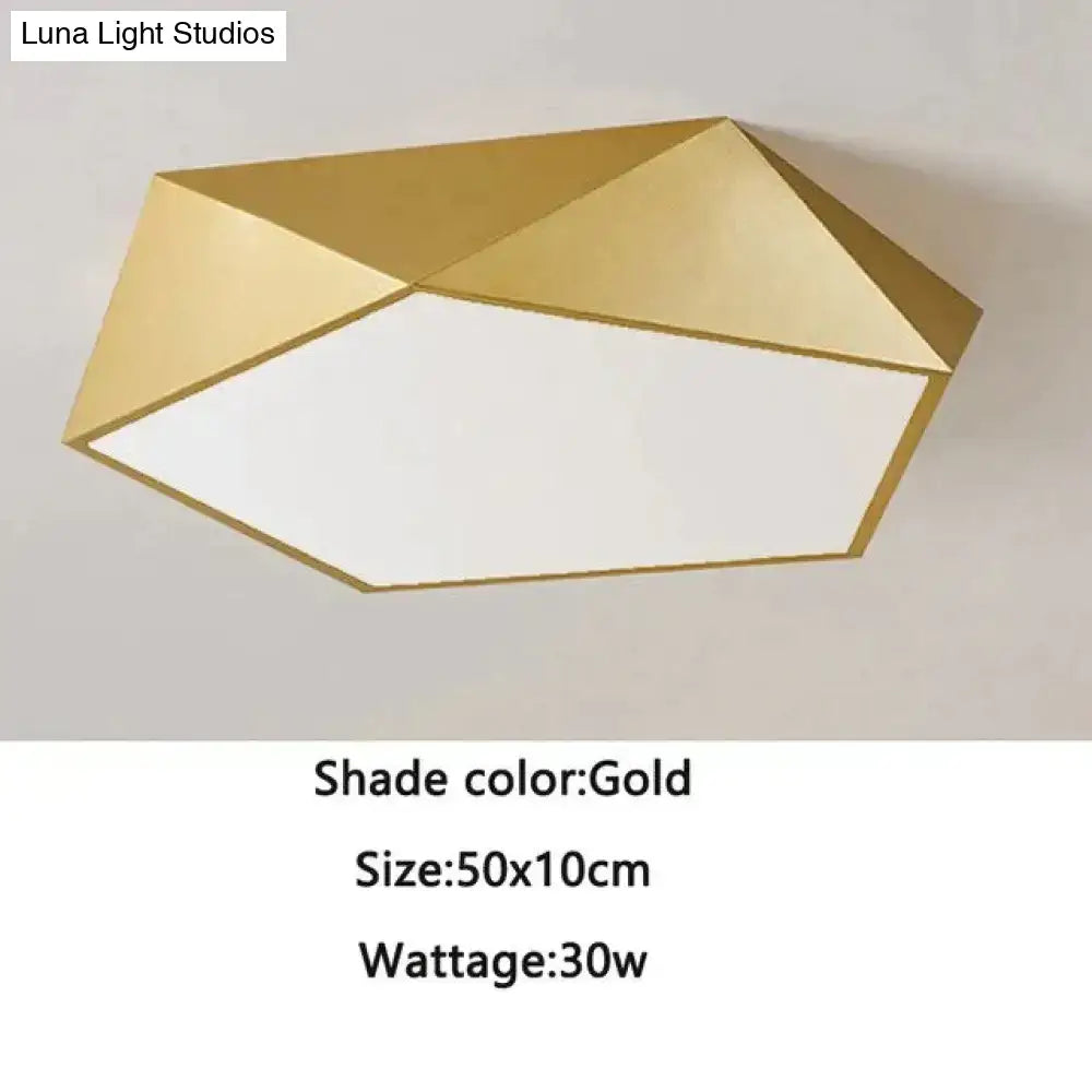 Gold geometric ceiling light with modern faceted design and white illuminated center for indoor living spaces