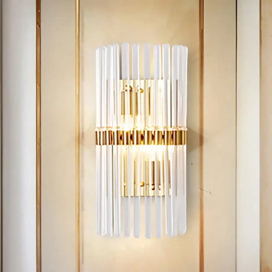 Modern gold finish wall light with vertical clear crystal frosted glass rods and central illuminated panel for living room